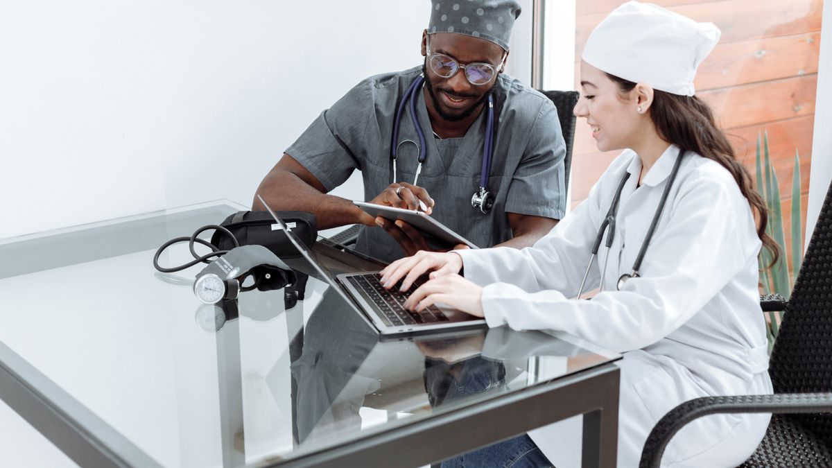 Two healthcare professionals reviewing workforce data together, building HR credibility