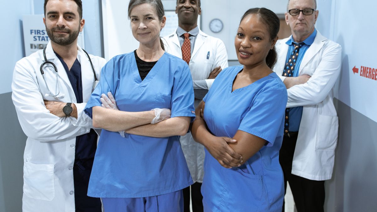 A team of nurses and physicians standing together in a hospital, representing nurse retention
